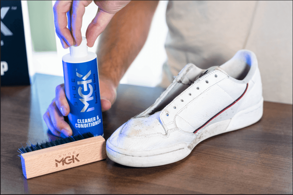 Man opens the bottle of the Shoe MGK Cleaner and Conditioner