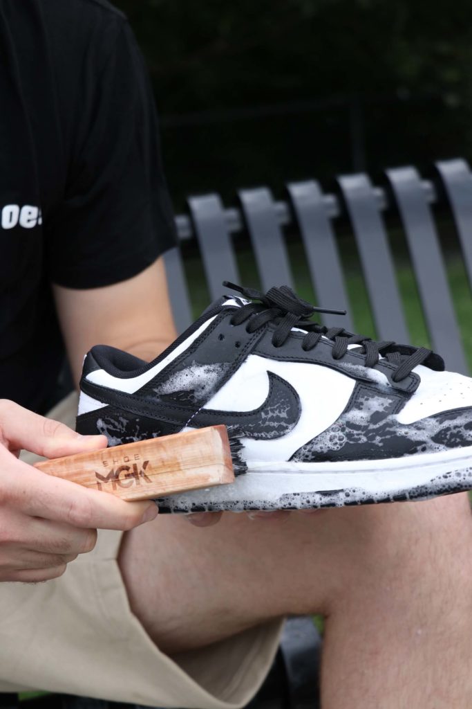 Man cleans Nike Dunks with Shoe MGK