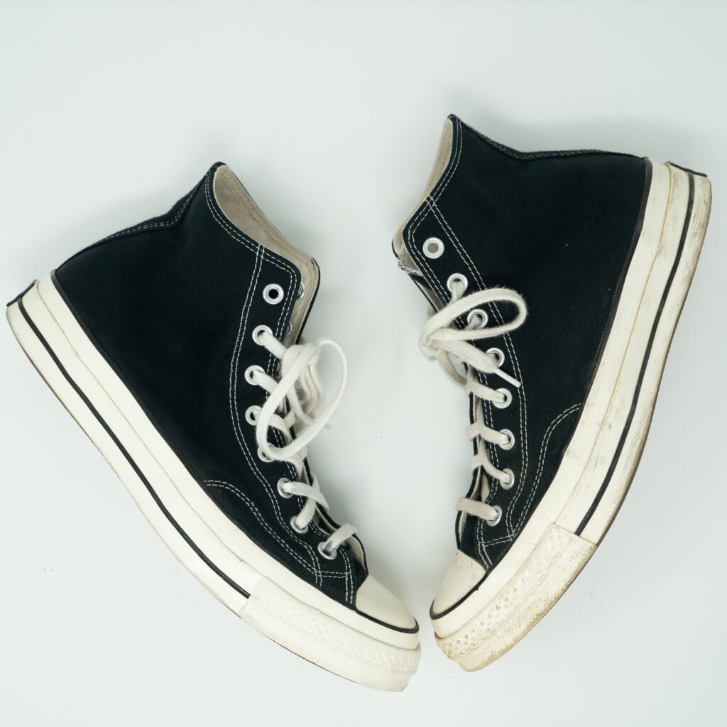 A side by side of clean and dirty converse shoes
