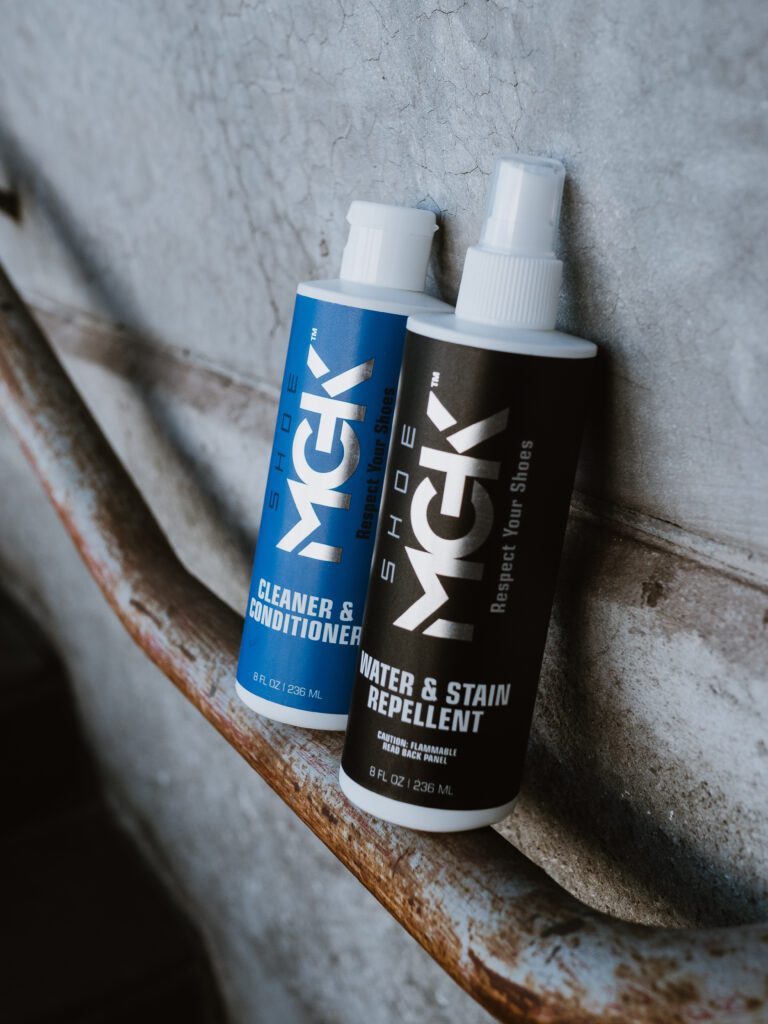 A bottle of the Shoe MGK Cleaner and Conditioner and the Shoe MGK Water and Stain Repellent