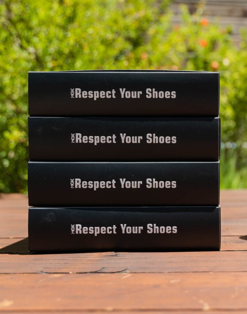 A pile of boxes that say Respect Your Shoes