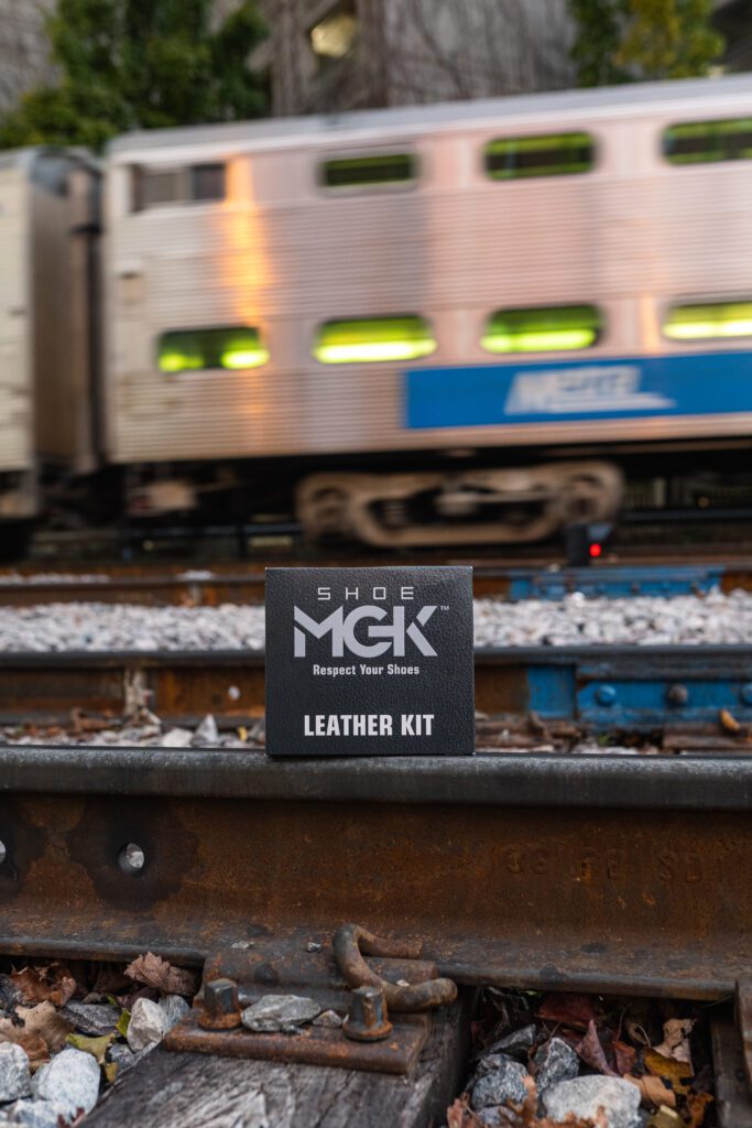 The Shoe MGK Leather Care Kit on a train track