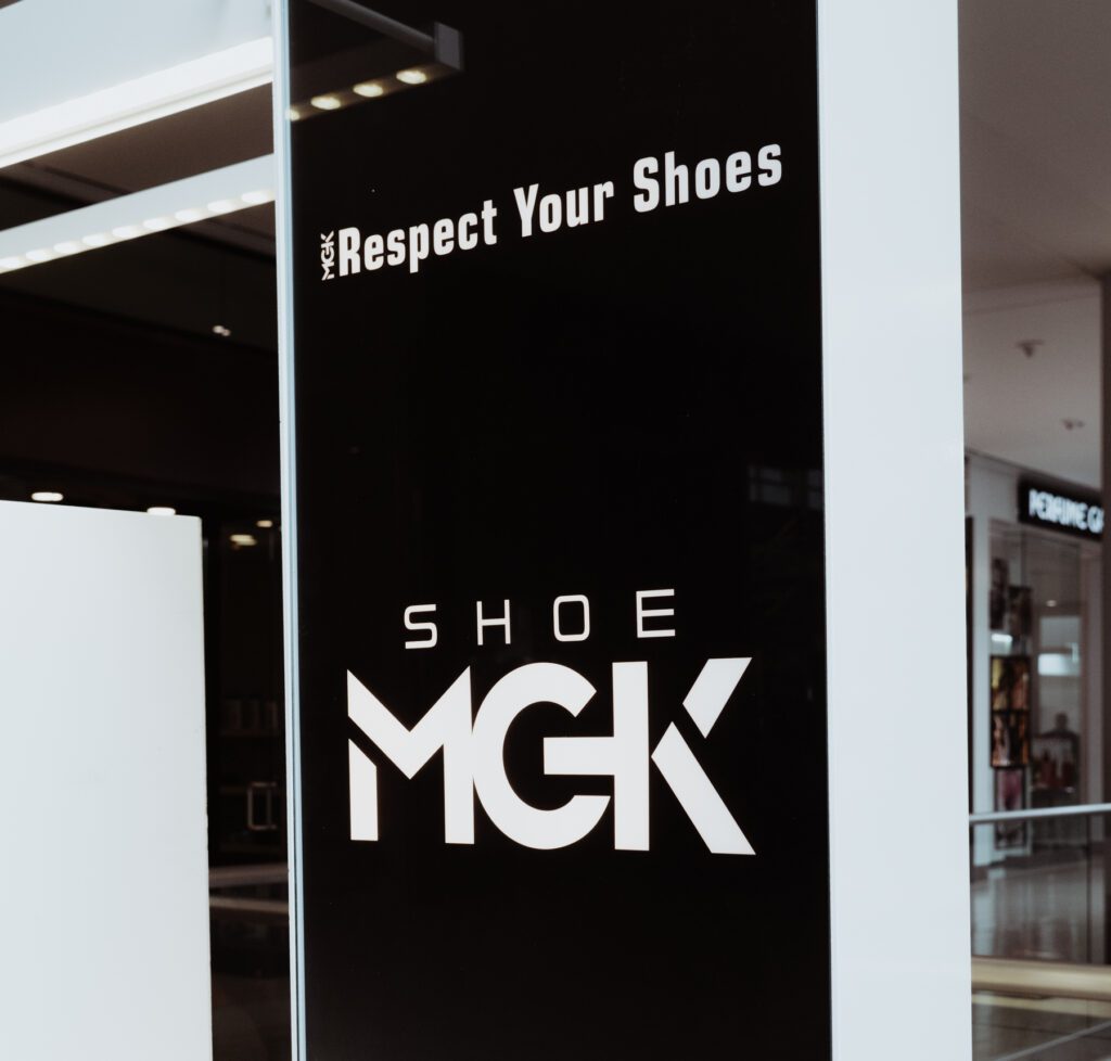 A Shoe MGK sign at a mall