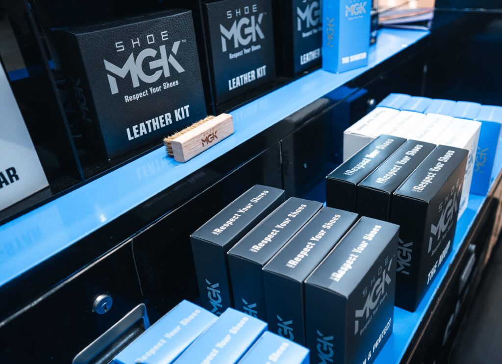 Shoe MGK products lined up at a mall kiosk