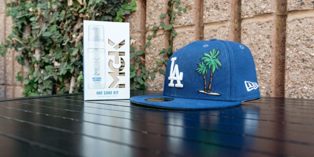 The Shoe MGK Hat Care kit next to a blue hat