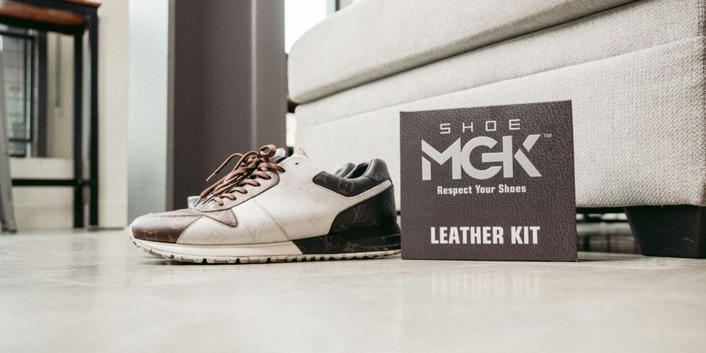 Louie Vuitton Runners next to the Shoe MGK Leather Care Kit