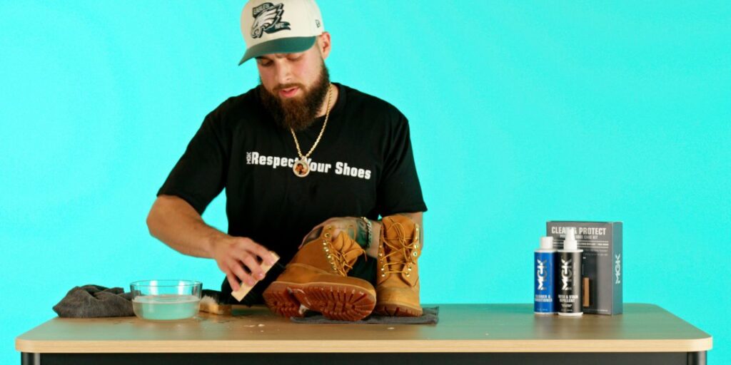Man cleans Timberland Premium Boots with Shoe MGK