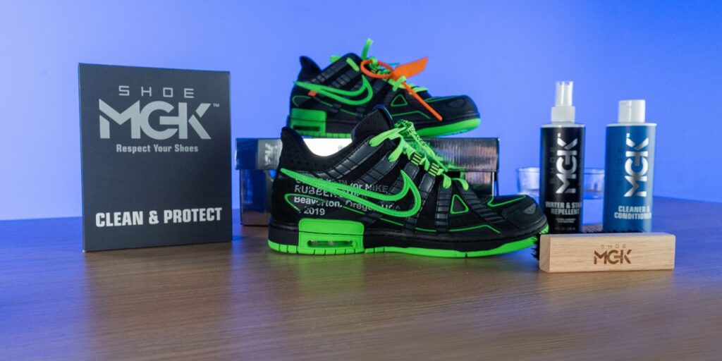 A pair of Nike Off-White x Air Rubber Dunks near the Shoe MGK Clean and Protect Kit