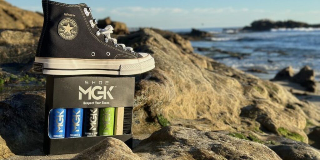 Converse High Tops on top of a box of the Shoe MGK Complete Kit at the beach