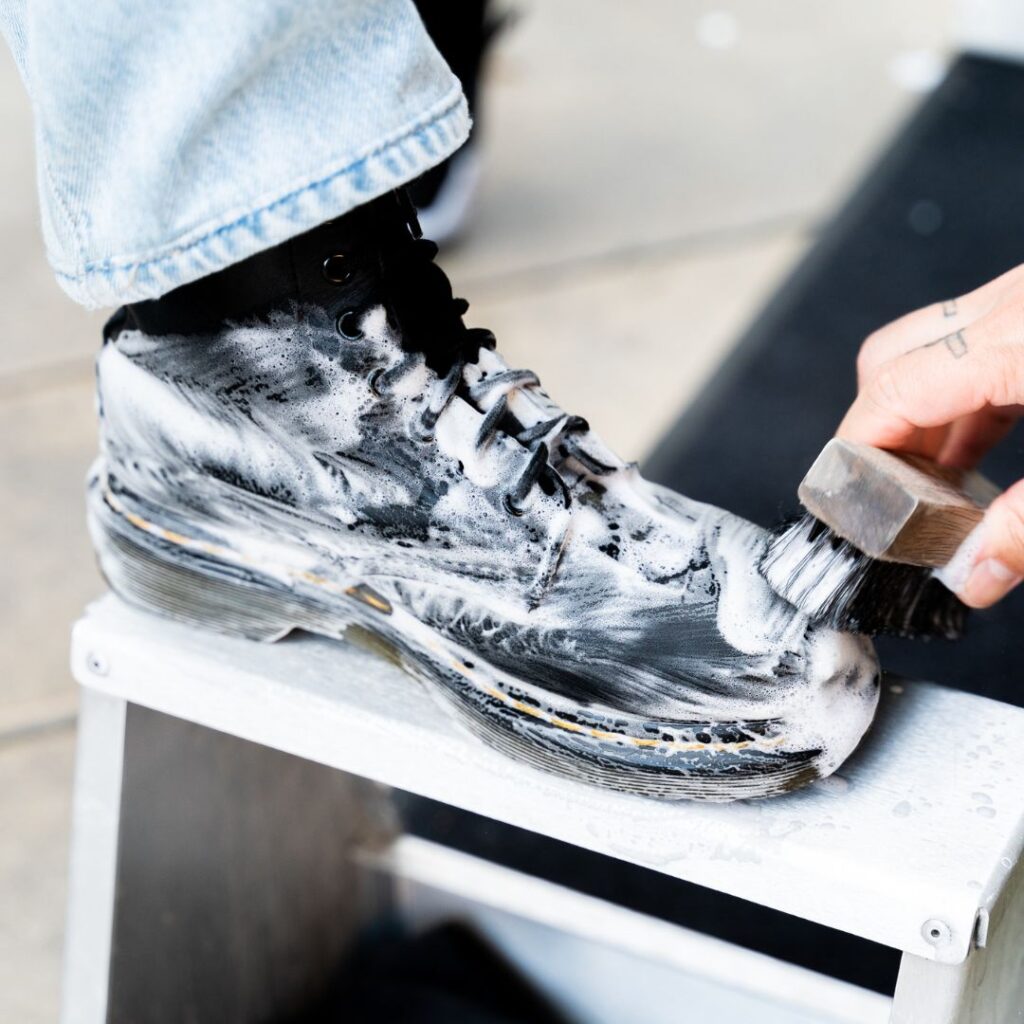Man cleans urban footwear with Shoe MGK