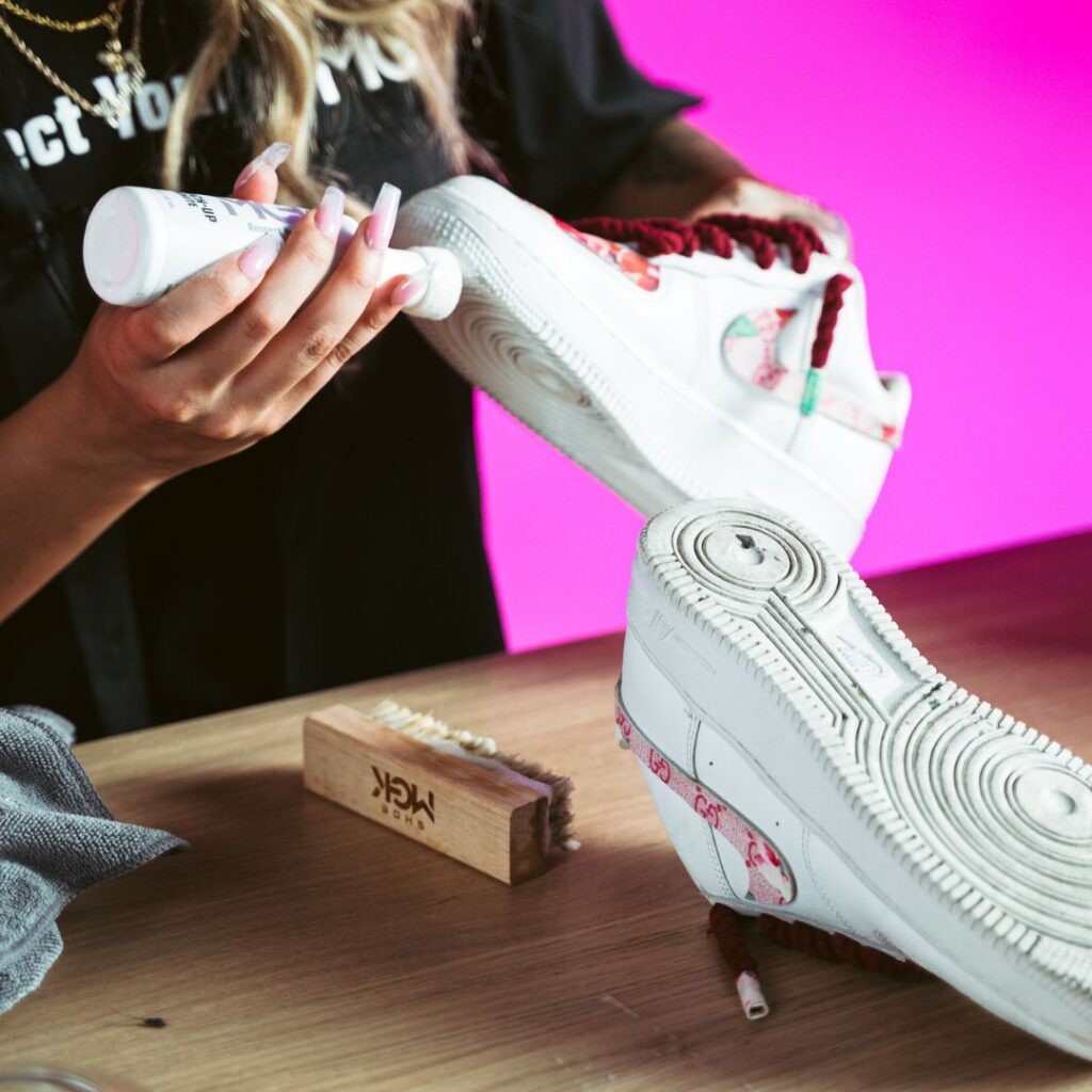 Woman restores white shoes with the Shoe MGK White Touch-Up