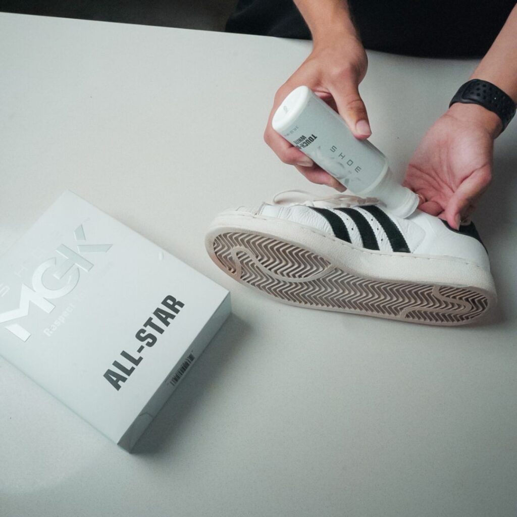 Man cleans white shoes with the All-Star Kit