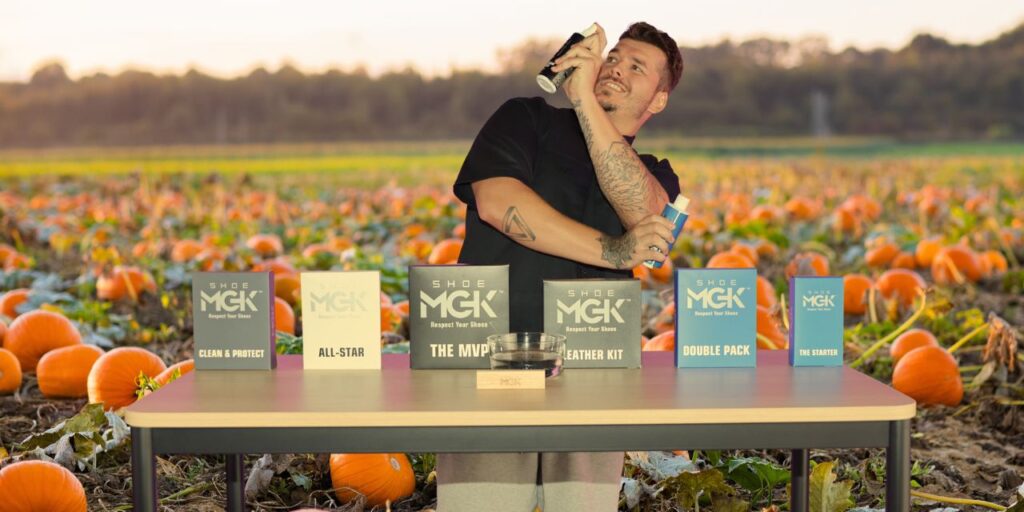 Man cleans shoes in a pumpkin patch