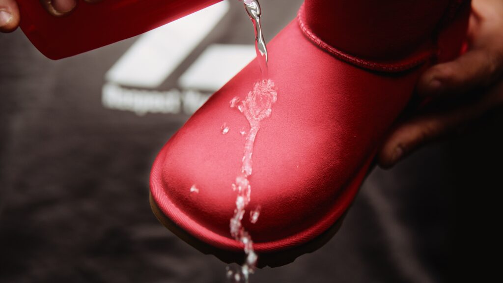 Man pours water onto waterproofed shoes