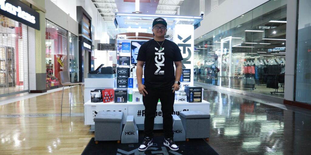 Man infront of a Shoe MGK Cart in a mall in Canada