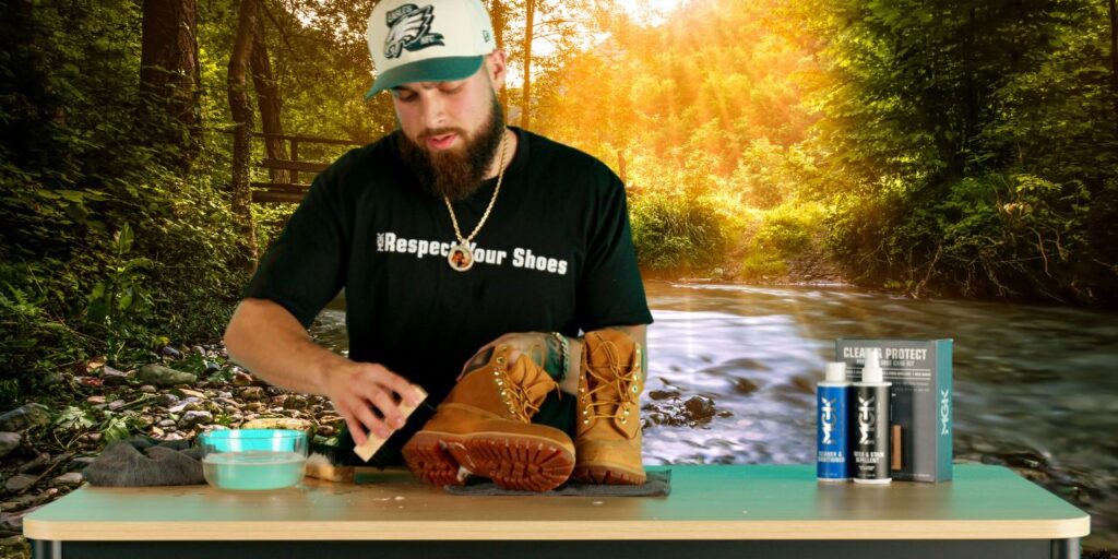 Man cleans boot while camping