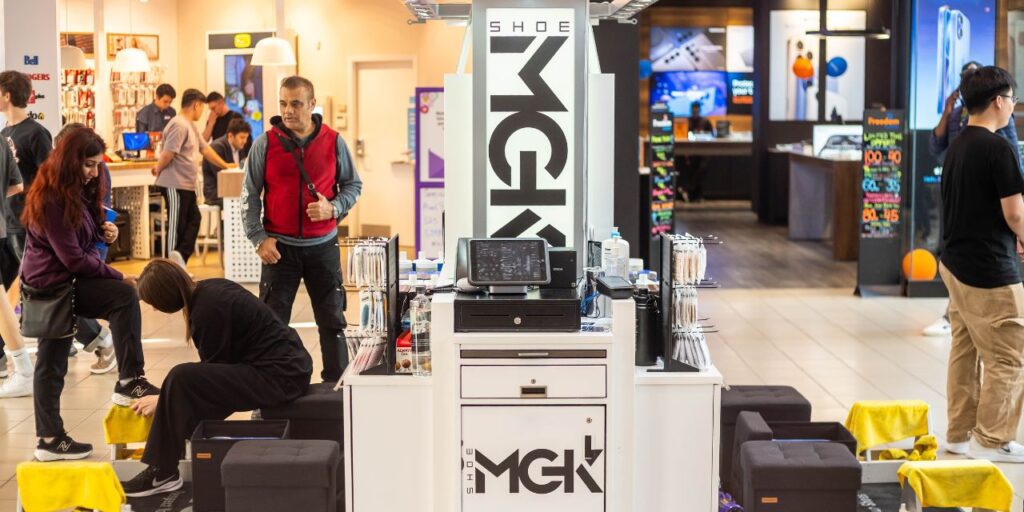 Shoe MGK Employees working at a Shoe MGK Mall cart