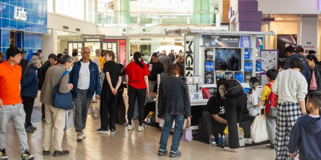 A bunch of people around a Shoe MGK cart