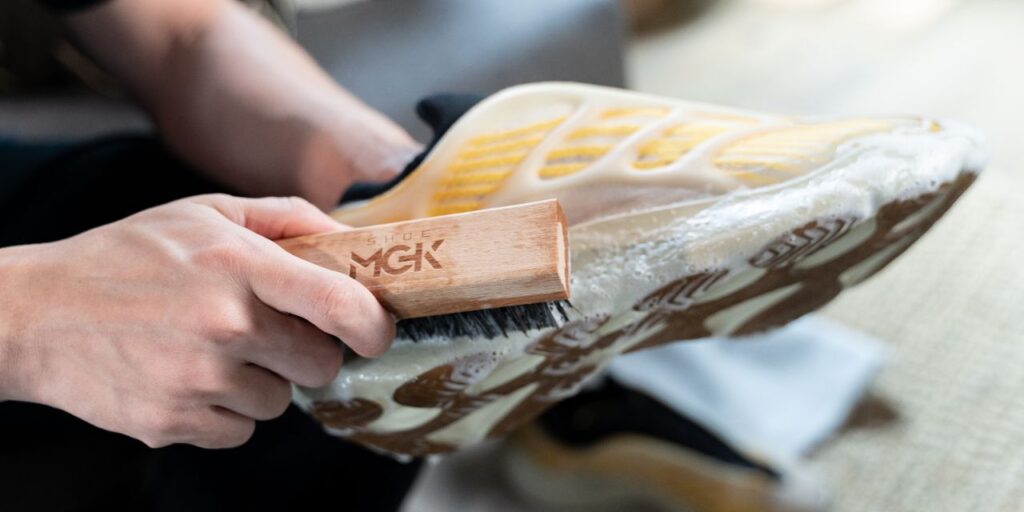 Man cleans shoes with Shoe MGK