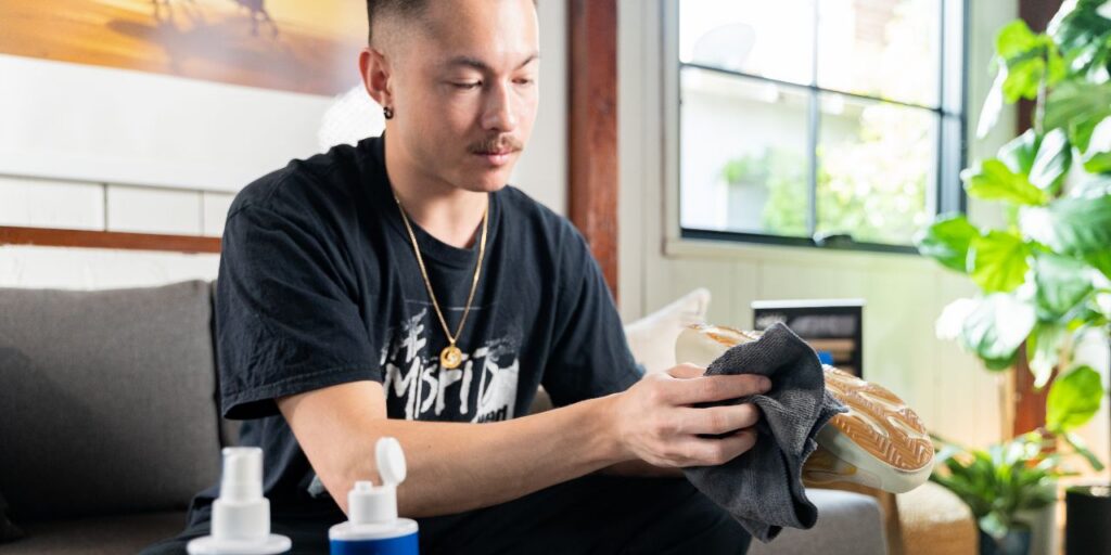 Man cleans shoes with Shoe MGK for Earth Day